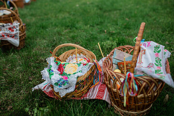 Easter baskets on the grass during the liturgy for Orthodox Easter. Consecration of Easter cakes and eggs with holy water
