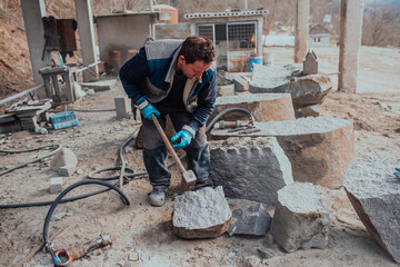 A stone pierces a factory worker. Heavy stone processing industry