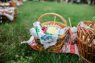 Easter baskets on the grass during the liturgy for Orthodox Easter. Consecration of Easter cakes and eggs with holy water