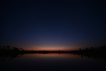 Deep colorful twilight and stars over Pine Glades Lake in Everglades National Park, Florida,
