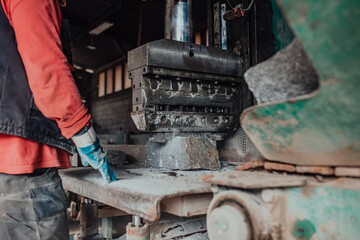 A worker in heavy industry breaks stone blocks using large machines. Granite and stone processing...