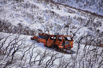 Truck old and rusty graffiti abandoned in the snow covered Mountains Lone Peak Wilderness Wasatch...