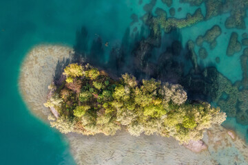 Aerial view of a lake surface and a small island