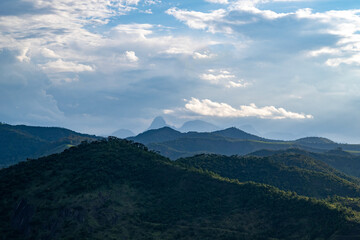 Landscape view of the mountains of Petropolis, Rio de Janeiro from a neighborhood in Areal, Brazil. On the front hill, the forest was made into a pasture