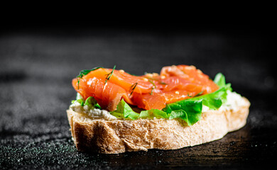 A flavorful salmon sandwich on the table. 