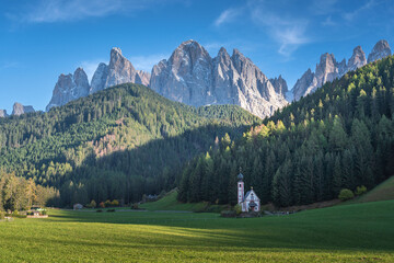 Fototapeta na wymiar Dolomite mountain landscapes, beautiful small village in Val di Funes, with church and mountains in Dolomite Alps, Italy