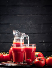 Juice from ripe tomatoes on the table. 