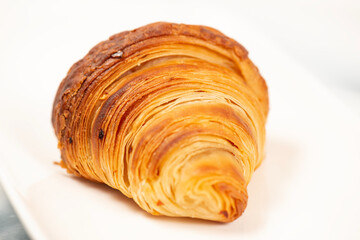 Golden crunchy fresh baked croissant using 75 percent butter weight and the method of three single folds.