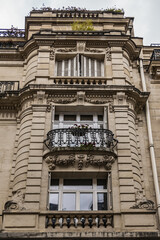 Fototapeta na wymiar Traditional old French house: balconies and windows. Paris, France.