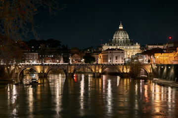 Fototapeta premium Ponte Sant'Angelo and St Peter Basilica at night in Rome, Italy