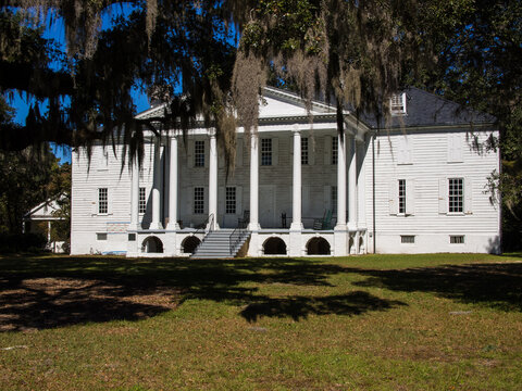 Historic Hampton Plantation, North Of Charleston, South Carolina, With Tree With Spanish Moss In The Foregroiund And Clear Blue Sky.