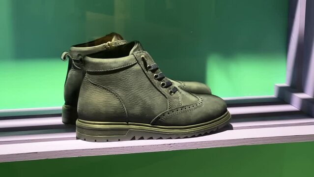 Women's high-soled lace-up suede boots are on the shelves of a shoe store