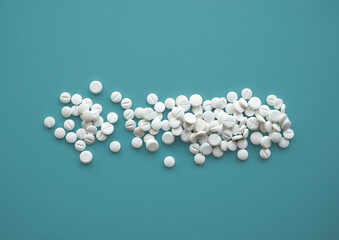 Handful pills spread cyan background