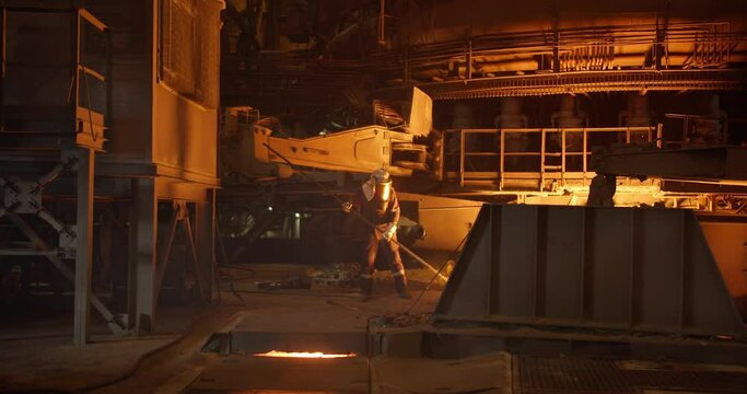 Metal casting process in metallurgical plant. Liquid metal pouring into molds