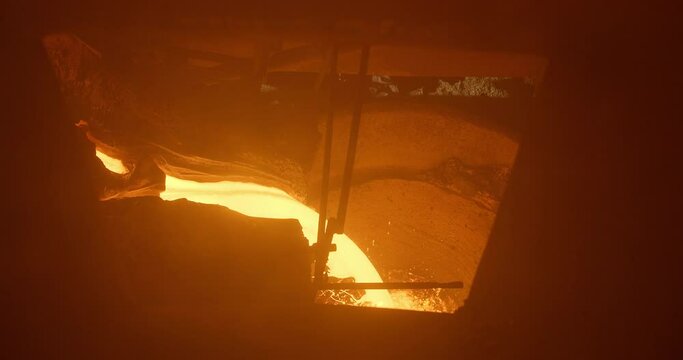 Metal casting process in metallurgical plant. Liquid metal pouring into molds