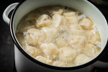 Dumplings are boiled in a saucepan in boiling water. 