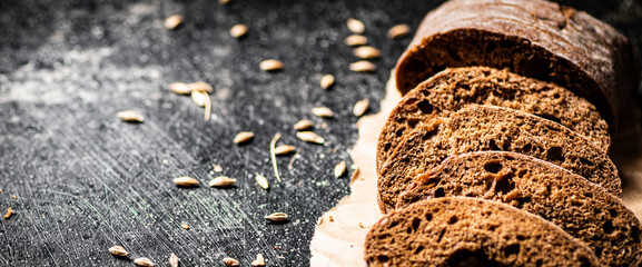 Sliced rye bread on paper. 