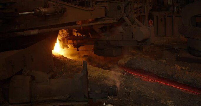 Metal casting process in metallurgical plant. Liquid metal pouring into molds