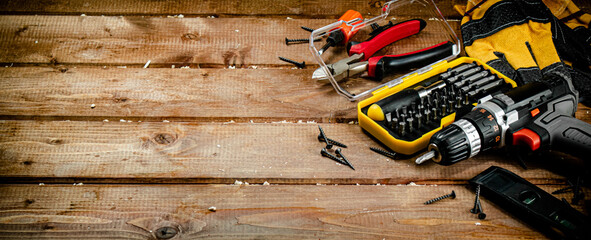 Working tool. Screwdriver with self-tapping screws on the table. 