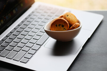 internet cookies internet browser cookies concept, mini cookies on keyboard computer laptop