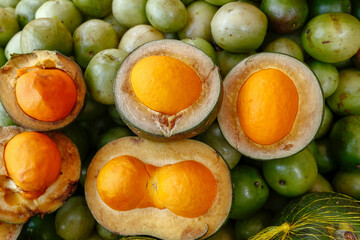 Pequi fruit in street market stall in downtown Sao Paulo city, Brazil