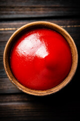 Tomato sauce in a bowl on the table. 