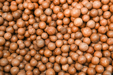 macadamia nuts texture background, fresh natural shelled raw macadamia nuts in a full frame, close up pile of roasted macadamia nut - top view