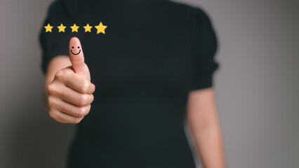 Customer satisfaction concept. Hand with thumb up Positive emotion smiley face icon and five star with copy space.