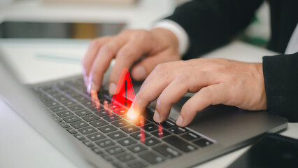 Computer notification error maintenance concept. programmer, or developer using a computer laptop with a triangle warning exclamation red sign trouble caution.