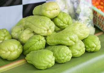 Fresh chayote fruits (Sechium edulis) on leaf background, Chayote or sweet gourd - Cucurbitaceae