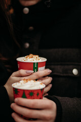 couple holding a cup of coffee