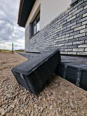 Black concrete brick pavement during laying process