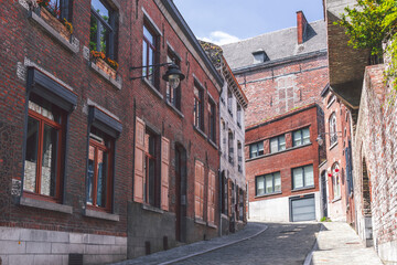 Old town of Mons with red brick houses along the street