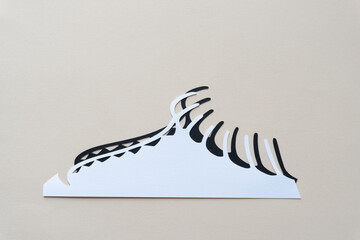 abstract paper shape with one straight bottom edge and a row of filaments or fringes on the other