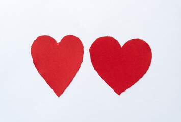 two hearts with torn edges on a white background