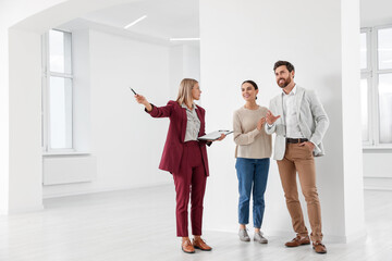 Real estate agent showing new apartment to couple