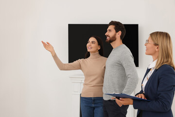 Fototapeta premium Real estate agent showing new apartment to couple