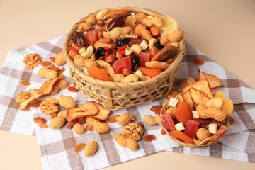 Mixed dried fruits and nuts on beige background
