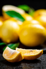 Fragrant lemons with leaves on the table. 
