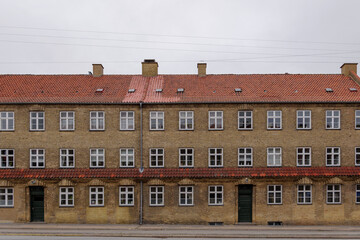 Fototapeta premium Exterior front elevation street view of typical old brick apartment in Copenhagen, Denmark. 