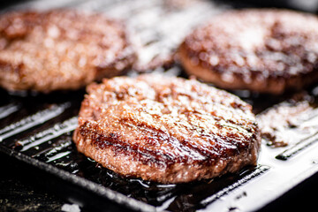 Grilled burger in a frying pan. 