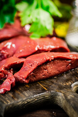 Sliced raw liver with greens. 