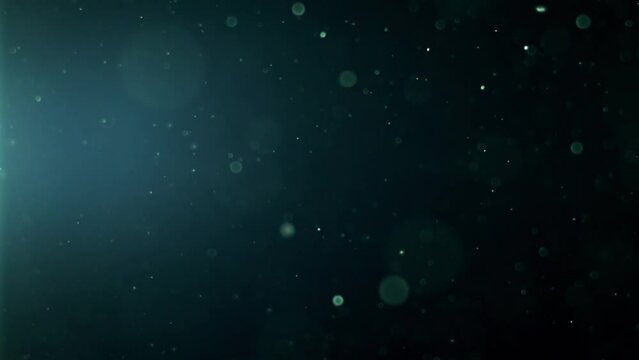 Abstract background with animation of flying and flickering particles as bokeh of light. Animation of seamless loop.Dust bubbles snow animation.Bokeh Shiny Particles Loop Animation.