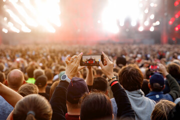 Taking photos of a rock concert on the mobile phone, open-air festival.