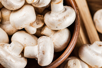 Mushrooms in a bowl on a cutting board. 
