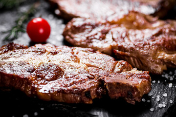 Grilled pork steak with cherry tomatoes and rosemary. 