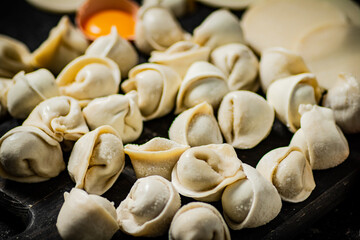 Dumplings with raw egg and pieces of dough. 