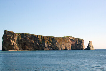 Fototapeta na wymiar Roché Percé, a natural hole in a huge rock in the ocean