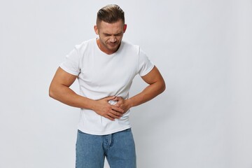 Man abdominal pain, gastritis and appendicitis inflammation, in white T-shirt on white isolated...