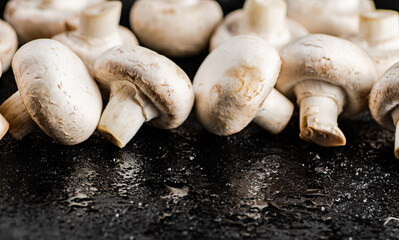 Fresh mushrooms champignons on the table. 